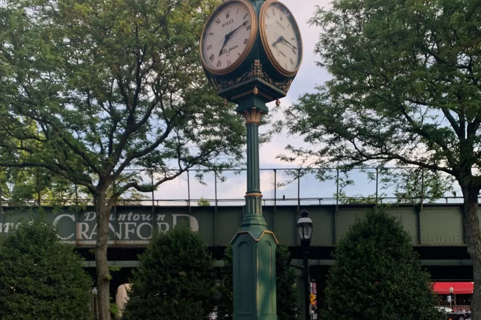 Historic clock surrounded by public seating in plaza in downtown Cranford, New Jersey.